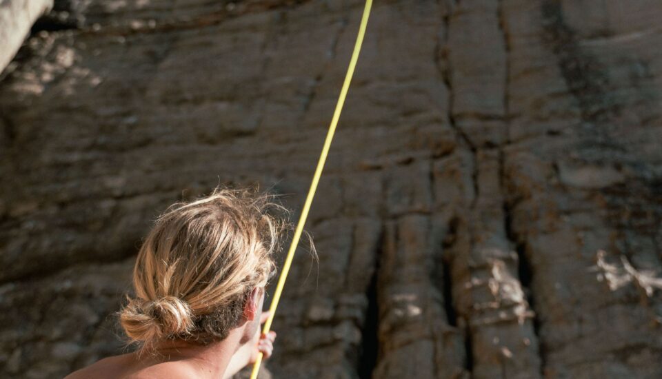 Photo by Liam Moore: https://www.pexels.com/photo/man-holding-climbing-rope-at-the-foot-of-a-rock-face-10867135/