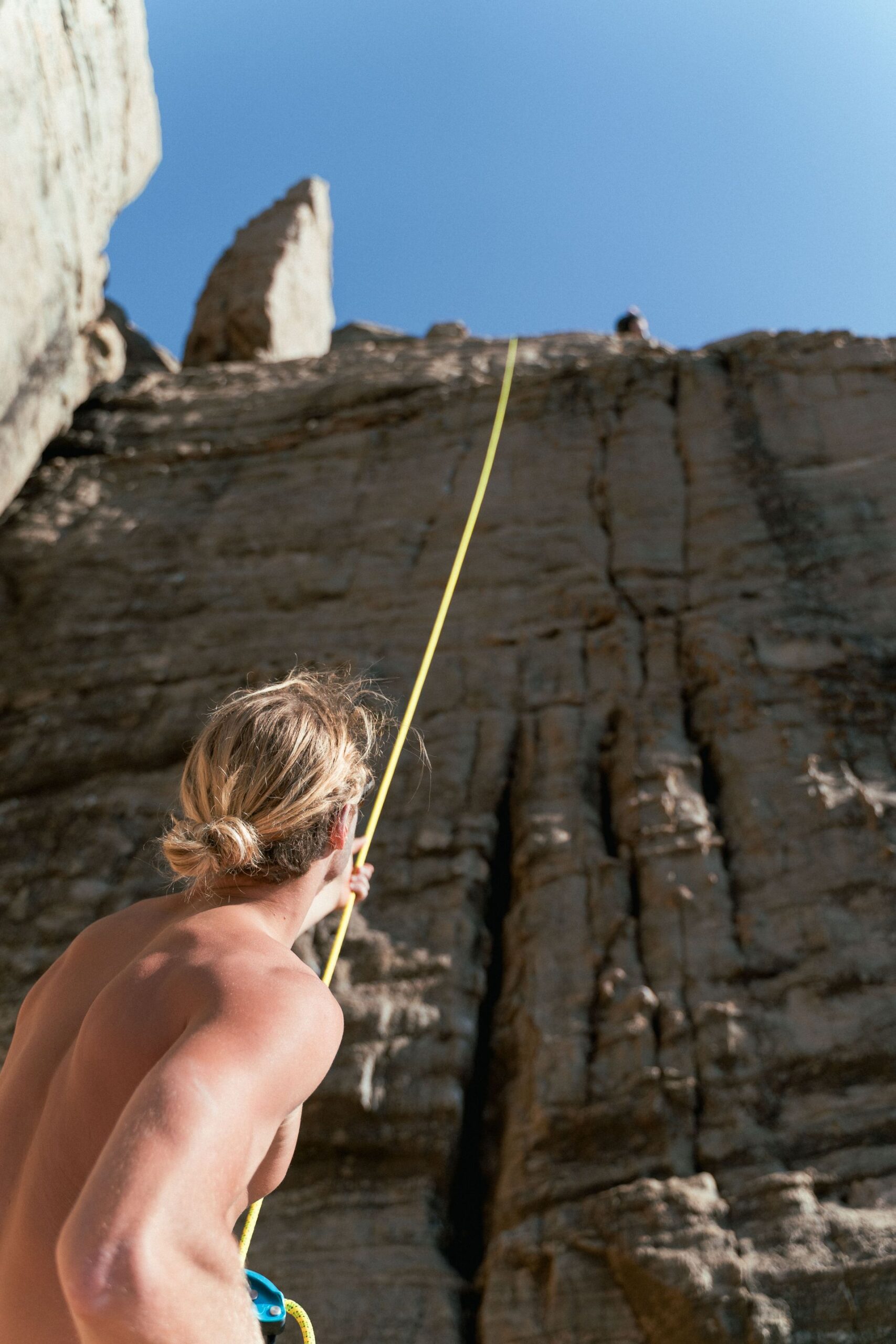 Photo by Liam Moore: https://www.pexels.com/photo/man-holding-climbing-rope-at-the-foot-of-a-rock-face-10867135/