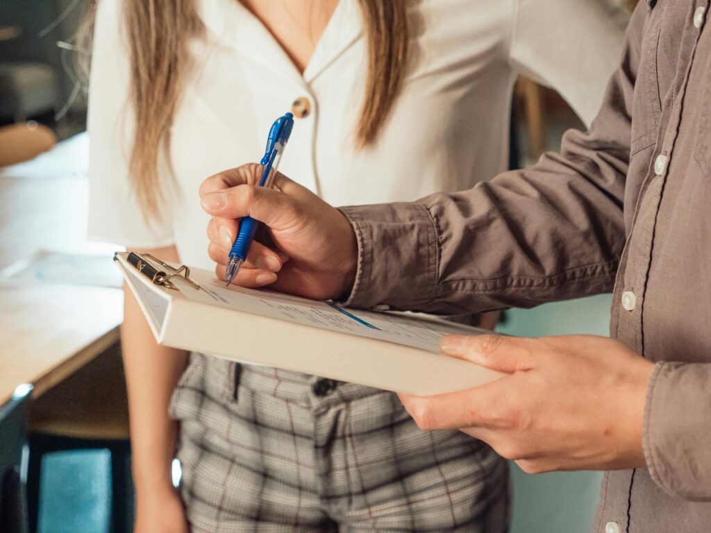 Hands holding a survey clipboard