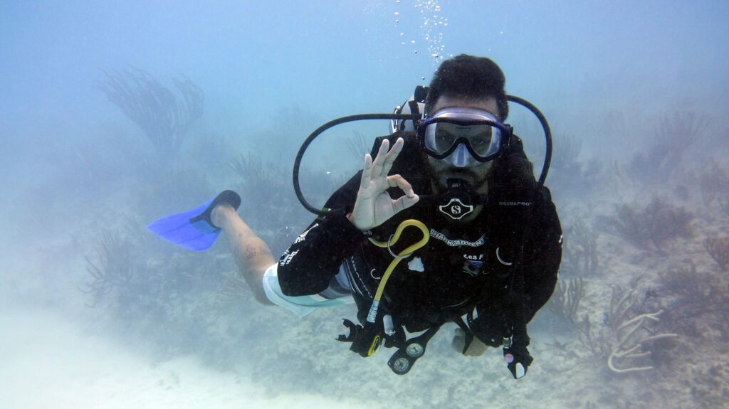 diver giving ok sign - not a thumbs up! 