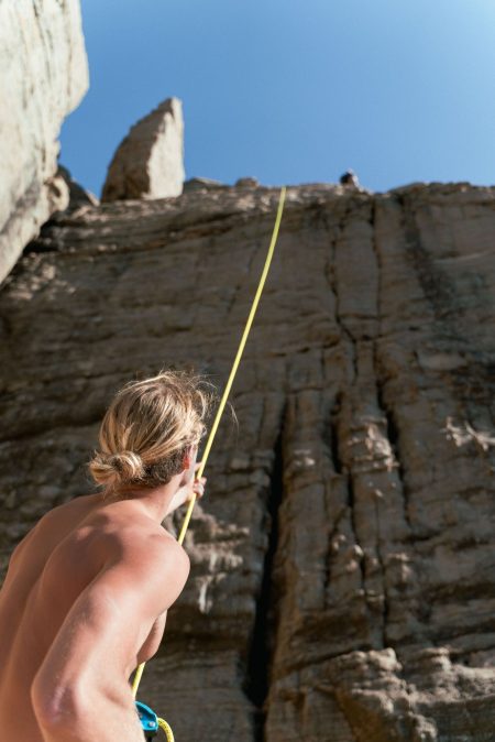 Photo by Liam Moore: https://www.pexels.com/photo/man-holding-climbing-rope-at-the-foot-of-a-rock-face-10867135/